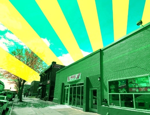 HUGE improv theater with a green and yellow sunburst graphic.